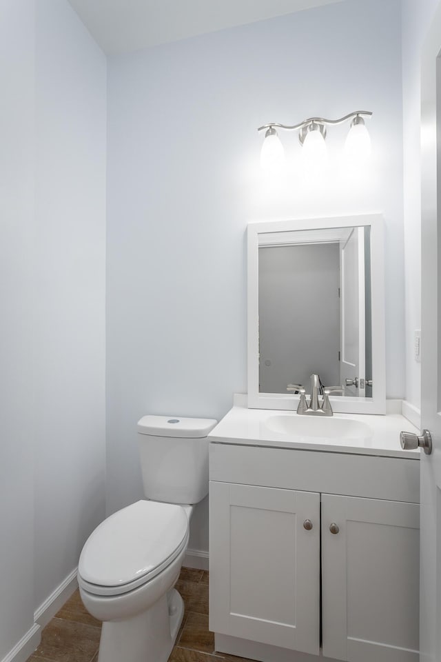 bathroom featuring toilet and vanity