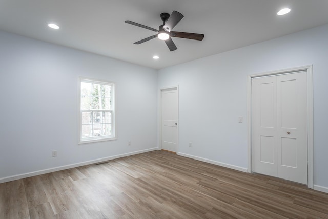 unfurnished bedroom featuring ceiling fan and light wood-type flooring