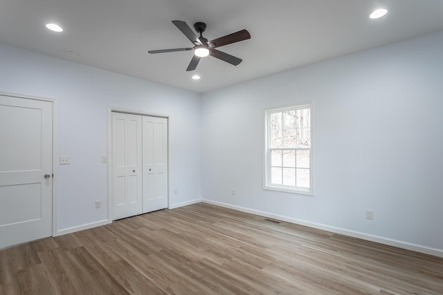 unfurnished bedroom with light wood-type flooring and ceiling fan