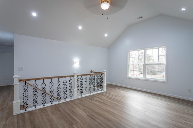 unfurnished room featuring ceiling fan, light hardwood / wood-style flooring, and lofted ceiling