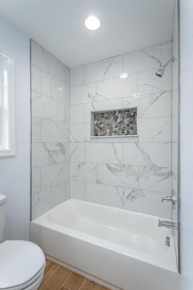 bathroom with toilet and shower / washtub combination