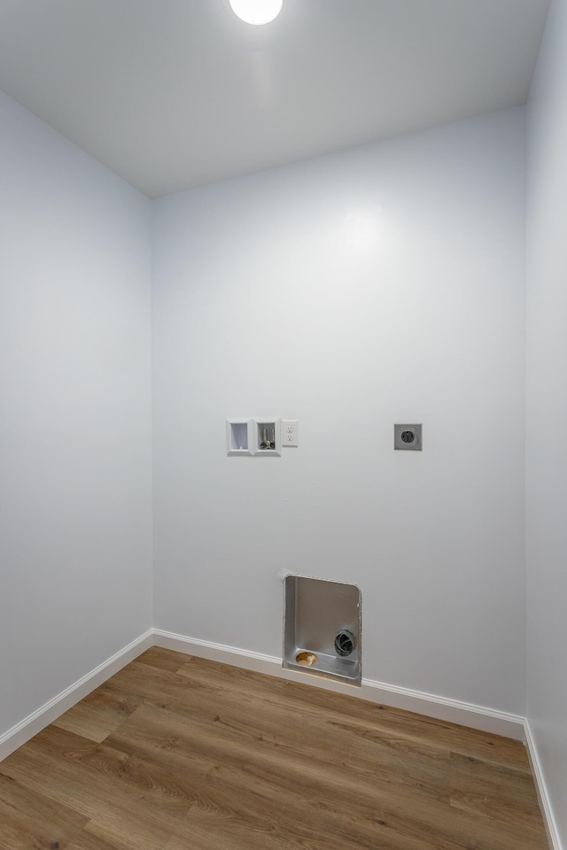 washroom with wood-type flooring, hookup for an electric dryer, and washer hookup