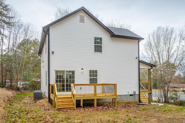 rear view of property featuring a wooden deck and central AC