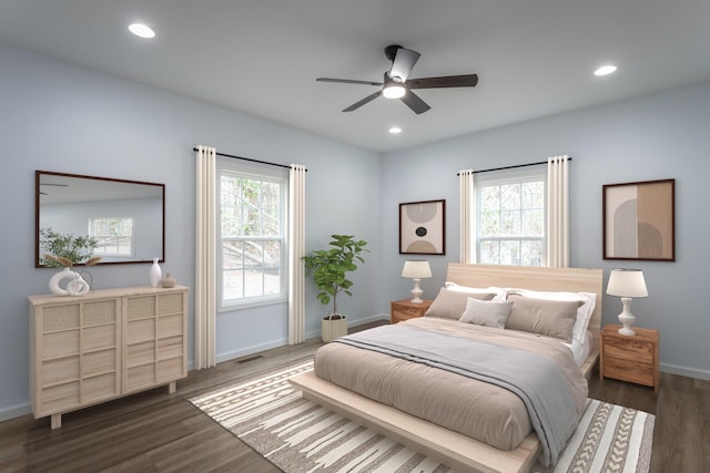 bedroom featuring ceiling fan, dark wood-type flooring, and multiple windows