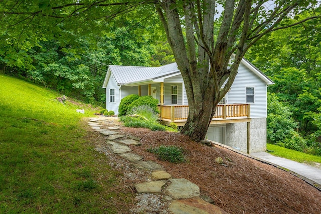 view of side of property featuring covered porch and a garage