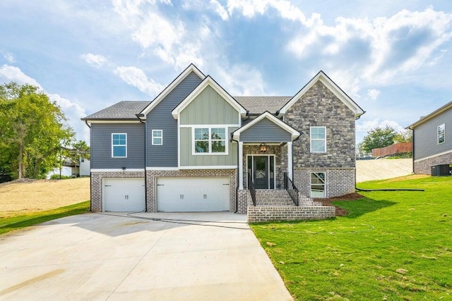 split foyer home with a front yard, central AC, and a garage