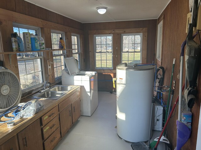 interior space featuring a sink, washer and clothes dryer, and gas water heater