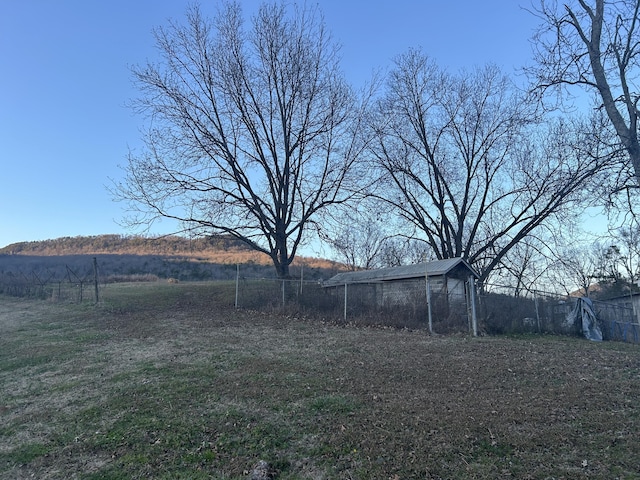 view of yard featuring a rural view and fence