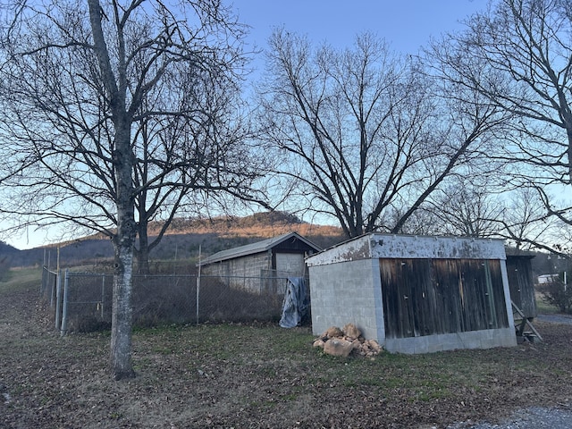 view of outbuilding featuring an outbuilding and fence