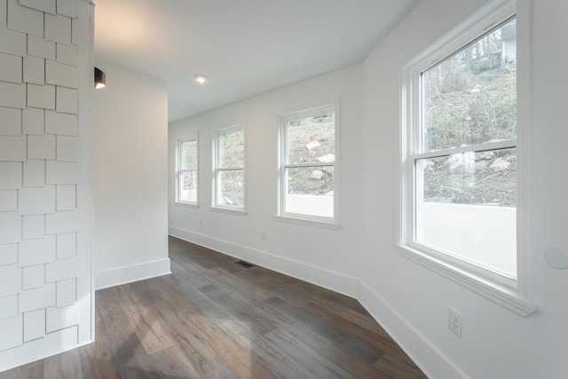 spare room featuring dark hardwood / wood-style flooring