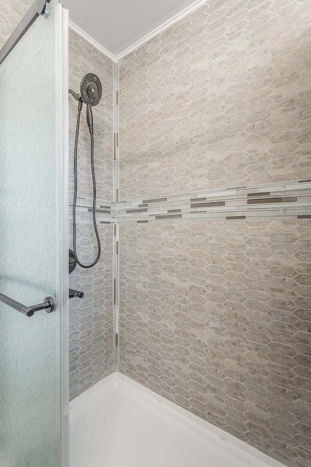 bathroom with tiled shower