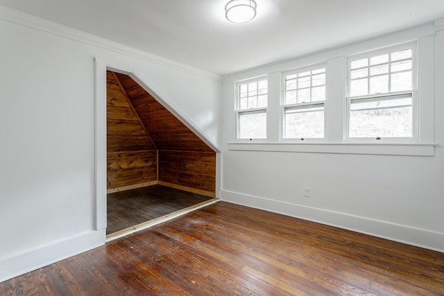 interior space with crown molding and dark wood-type flooring