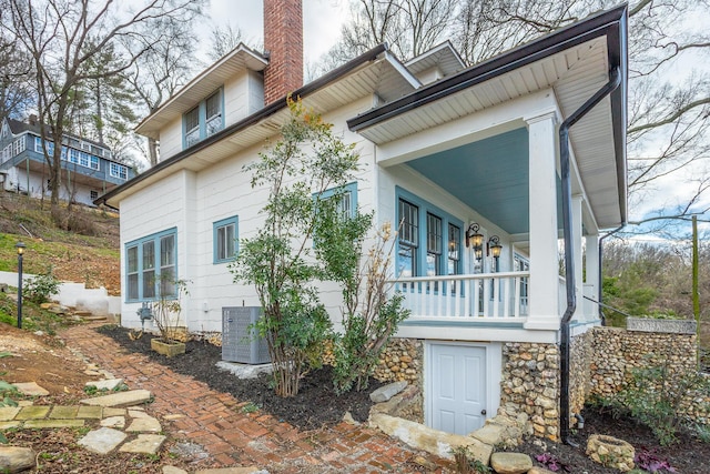 view of home's exterior featuring central AC and a balcony