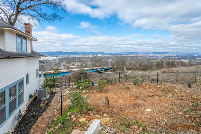 view of yard with a mountain view and central AC unit