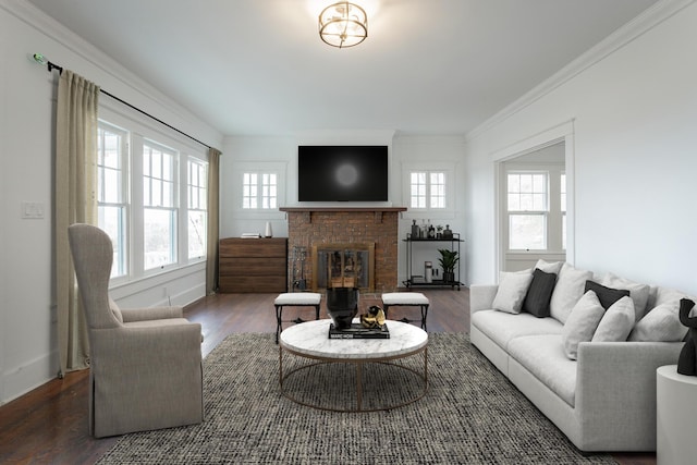 living room featuring dark hardwood / wood-style flooring, a brick fireplace, and plenty of natural light