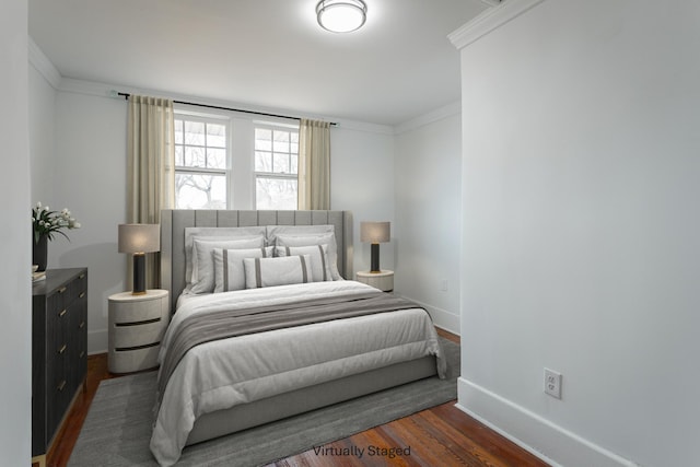 bedroom featuring crown molding and dark hardwood / wood-style floors