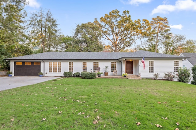 single story home with a garage and a front lawn