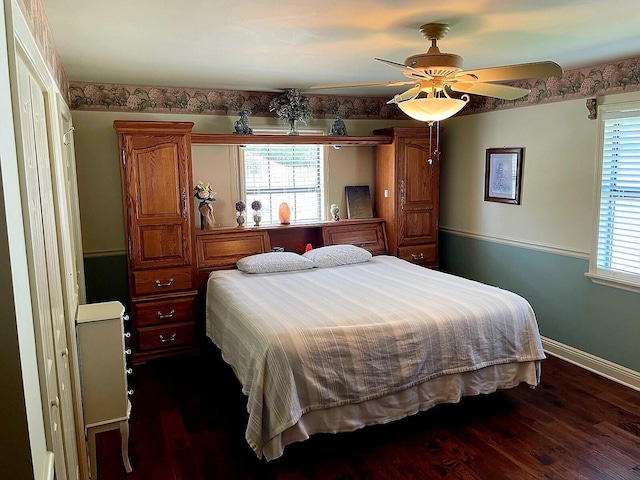 bedroom with ceiling fan and dark hardwood / wood-style floors