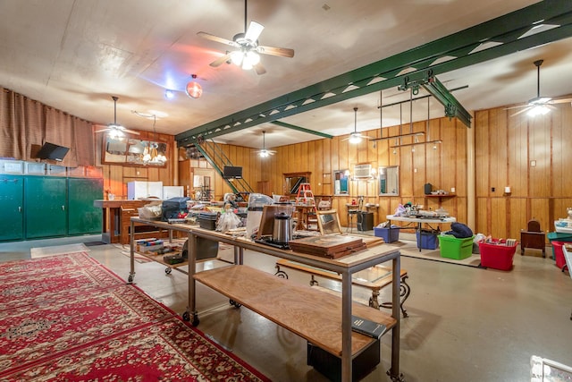 dining space with wood walls and concrete flooring