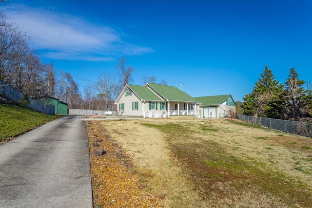 view of front of property with a front yard, covered porch, and a garage