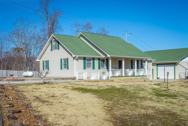 view of front of property featuring a garage, a front lawn, and a porch