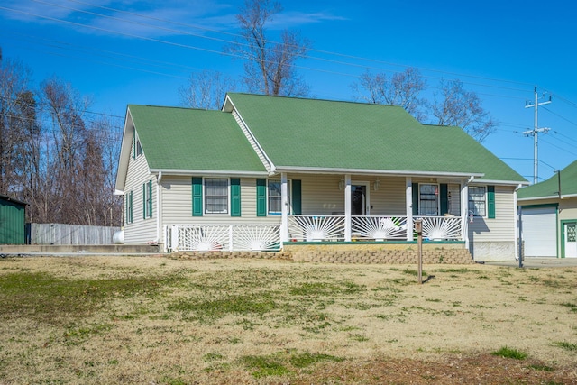 cape cod home with a front yard and a porch