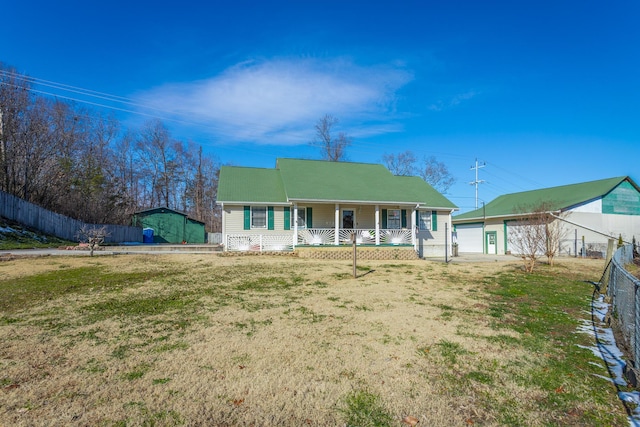 view of front of property featuring a front yard, covered porch, and a garage