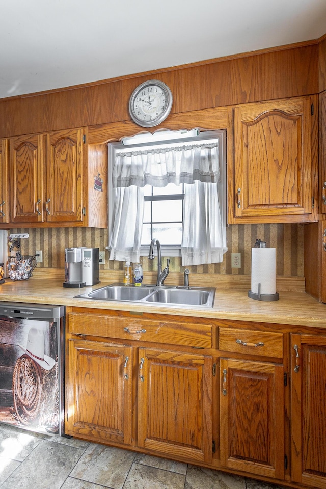 kitchen featuring sink, dishwasher, and tasteful backsplash