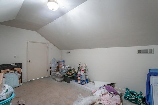 additional living space featuring lofted ceiling and light colored carpet