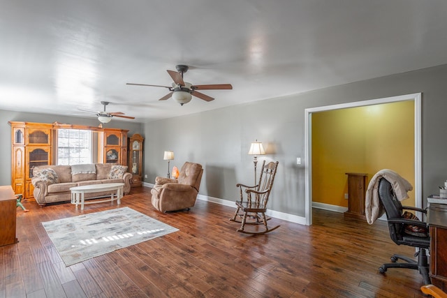 living room with ceiling fan and dark hardwood / wood-style flooring