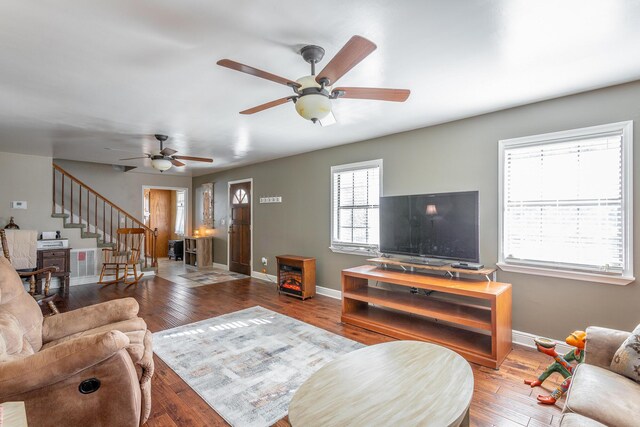 living room featuring ceiling fan and hardwood / wood-style flooring