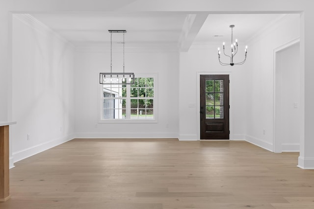 foyer featuring ornamental molding, light hardwood / wood-style flooring, and a notable chandelier