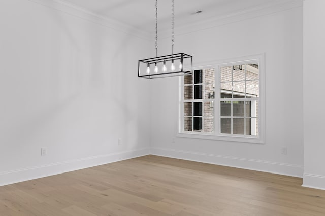 unfurnished dining area featuring light hardwood / wood-style flooring and crown molding