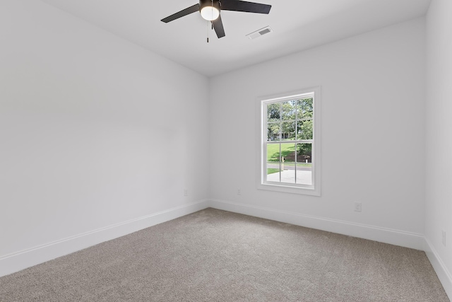 carpeted empty room featuring ceiling fan