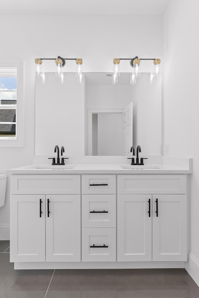 bathroom featuring tile patterned floors, vanity, and toilet