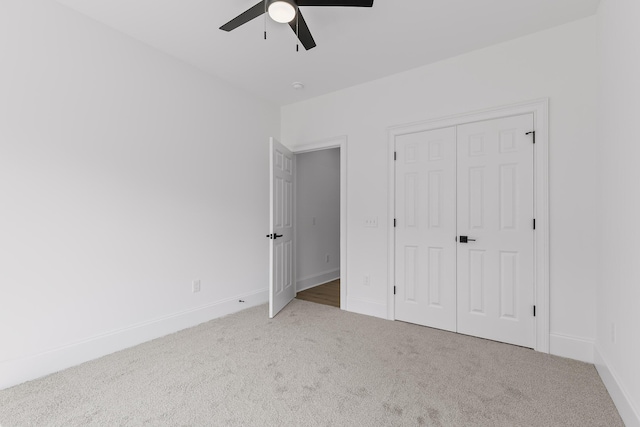 unfurnished bedroom featuring ceiling fan, carpet floors, and a closet