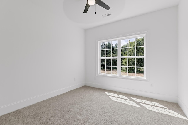 carpeted empty room featuring ceiling fan