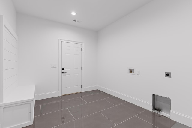 clothes washing area featuring washer hookup, dark tile patterned flooring, and electric dryer hookup