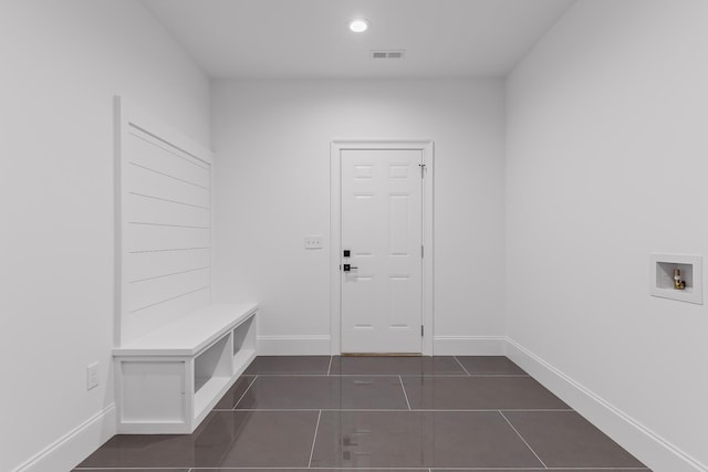 mudroom featuring dark tile patterned flooring