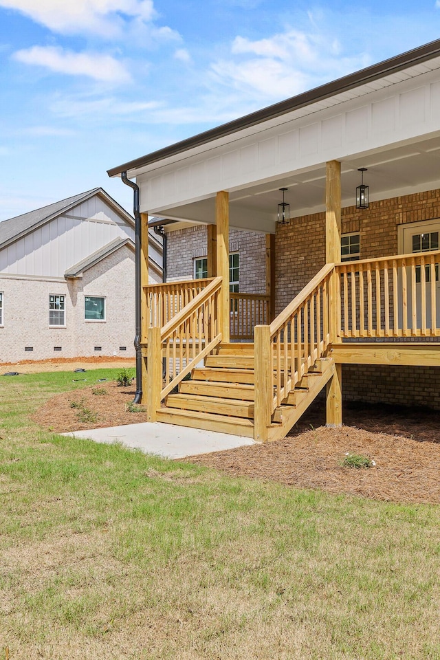 back of house featuring a porch and a yard