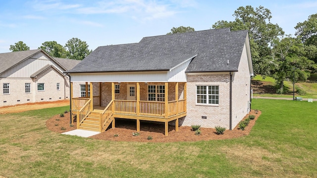 back of property featuring a lawn and a deck