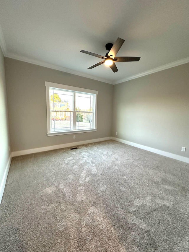 carpeted empty room featuring ceiling fan and ornamental molding