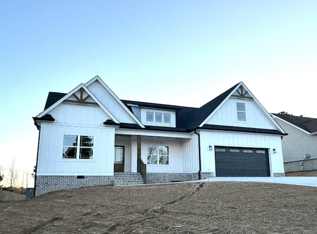 modern farmhouse with covered porch and a garage