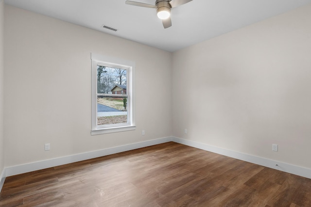 spare room featuring wood-type flooring and ceiling fan