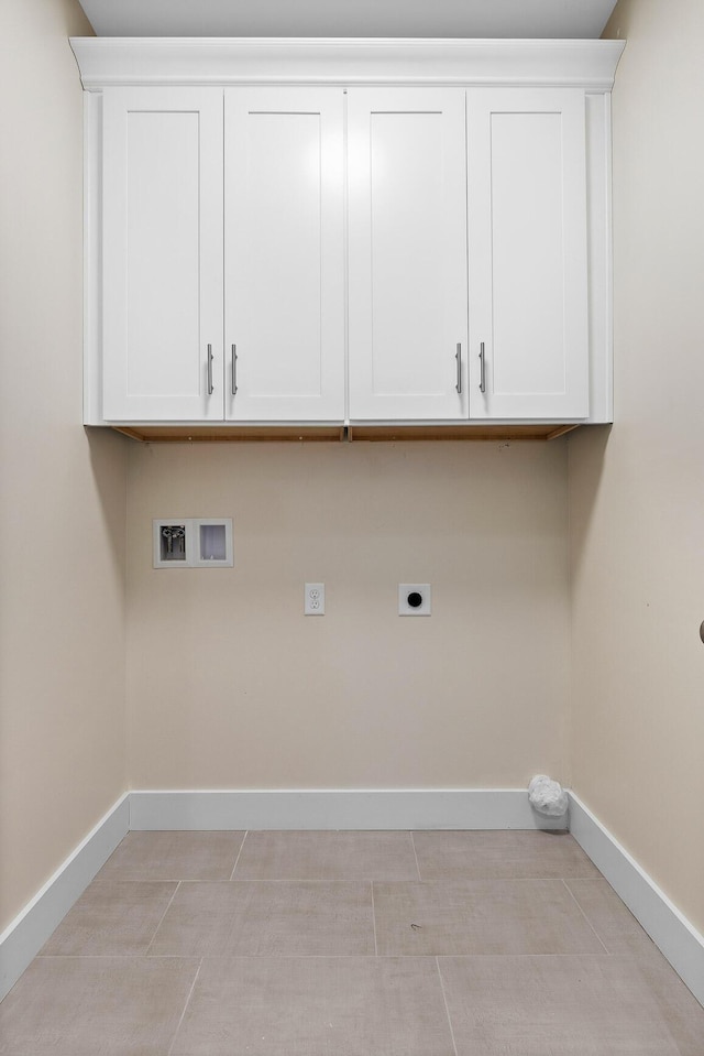 laundry area featuring hookup for an electric dryer, washer hookup, and cabinets