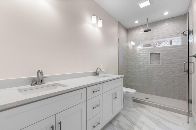 bathroom featuring vanity, toilet, and an enclosed shower