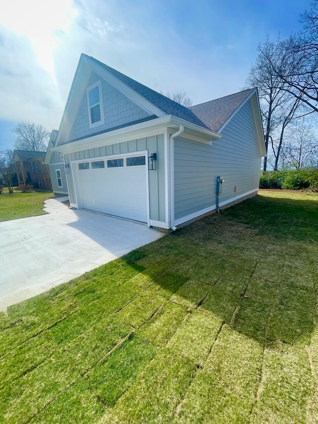 view of home's exterior with a yard, board and batten siding, concrete driveway, roof with shingles, and a garage