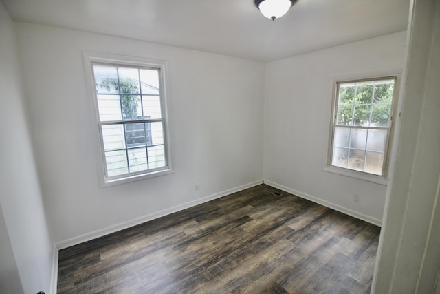 empty room with dark hardwood / wood-style flooring