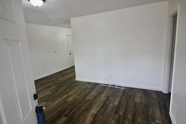 empty room featuring dark hardwood / wood-style flooring