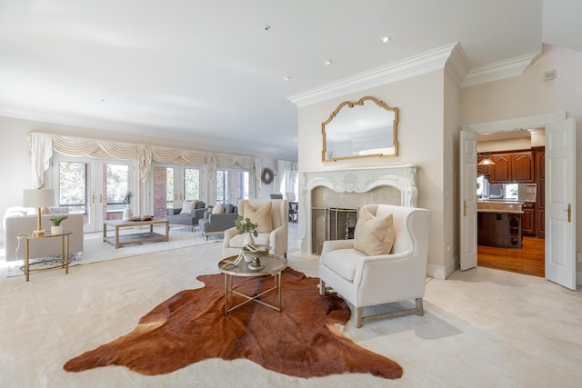 interior space with crown molding, french doors, a high end fireplace, and light carpet